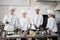 Portrait of multiracial team of cooks in professional kitchen