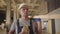 Portrait of a muscular Caucasian builder with brown eyes eating bun at the construction site. Strong young worker having