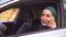 Portrait muslim businesswoman in hijab in the car and talking on the phone