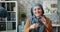 Portrait of Muslim businesswoman in hijab holding glasses sitting in office