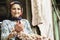 Portrait of a Muslim senior woman having bunch of fresh root of garlics in hands