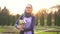 Portrait muslim student with books in hijab with a backpack on her back in the park at sunset