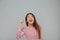 Portrait of a n amused happy asian woman pointing finger