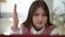 Portrait of nerd intelligent teen schoolgirl raising hand wishing answer question sitting with laptop having online