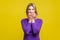 Portrait of nervous anxious woman biting her nails. indoor studio shot isolated on yellow background