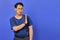 Portrait of nervous anxious young Asian man make stop don\\\'t move gesture over purple uebackground