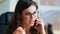 Portrait nervous businesswoman speaking cellphone in office. Woman calling phone