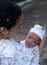 Portrait of a newborn baby infant  hold close by mother in the garden, close up. Family