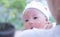 Portrait of a newborn baby infant  hold close by mother in the garden, close up. Family