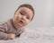 Portrait of a newborn baby lying on his stomach in an orthopedic collar.