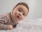 Portrait of a newborn baby lying on his stomach in an orthopedic collar.