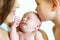 Portrait of newborn baby next to mom and brother