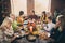 Portrait of nice attractive cheerful cheery positive glad family parents grandparents eating harvest tradition