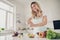 Portrait of nice attractive cheerful wavy-haired lady making healthy weightloss vitamin tasty yummy delicious dinner