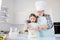 Portrait of nice cheerful kind grey-haired grandpa grandchild cooking homemade domestic dough dish meal easter pizza pie