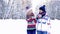 Portrait of nice couple walking in the winter forest