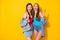 Portrait of nice-looking attractive glamorous lovely fashionable funky cheerful cheery girls eating icecream having fun