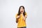 Portrait of nice shocked positive cute young girl in casual yellow shirt, opened mouth, isolated over white background