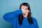 Portrait of nice young person arms palms covering face eye peeking isolated on blue color background