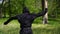 Portrait of a ninja in a black suit, slow motion. Ninja is training in martial arts