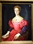 Portrait of a noble woman, with light hair and a red dress with blue sleeves, at the Uffizi museum in Florence.