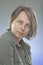 Portrait of a normal girl looking camera. / Beautiful woman portrait over grey background