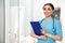 Portrait of nurse with clipboard in hospital. Medical assisting