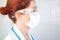 Portrait of a nurse or doctor with protective surgical mask and glasses