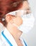 Portrait of a nurse or doctor with protective surgical mask and glasses