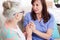 Portrait nurse holding hands elderly woman in clinic home