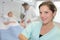 Portrait nurse patient in hospital bed in background