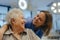 Portrait of nurse and senior patient talking in hospital corridor. Emotional support for elderly woman.