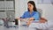 Portrait of nurse typing on laptop looking at camera