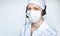 Portrait octor in headset wearing protective mask on white background, with blank copyspace area for text