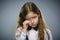 Portrait of offense crying girl isolated on gray background. Negative human emotion, facial expression. Closeup