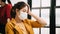 Portrait of office woman touching her head feeling unwell and get fever at the office, one of the symptoms of coronavirus Covid