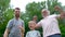 Portrait og happy family - grandpa, father and his son smiling and showing their muscles outdoor in park on background