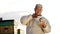 Portrait of old asian farmer man or smiling senior pours honey into container