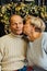 portrait of old couple wife and husband hugging and smiling. Dark blue background. Happy lovers on retirement. Stop