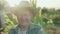 Portrait of the old farmer in a field smiling and speaking at camera 4K