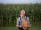 Portrait of old farmer with white beard in corn field