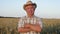 Portrait Old Man In Hat With His Arms Crossed In Front Of Him In Wheat Field