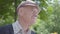 Portrait old man sitting on a bench in the park. Adorable mature grandfather resting on a sunny warm spring day outdoors