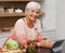 Portrait, old woman and online for cooking and tablet in kitchen and watch for learning, meal prep and guide. House