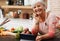 Portrait, old woman and video of cooking and tablet in kitchen and watch for learning, meal prep and guide. House