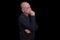 portrait of older bearded man pensive and watching isolated on black background