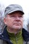 Portrait of an older man in a cap on the background of nature