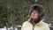 Portrait older woman standing in coniferous forest on winter day