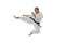 Portrait of one caucasian sportsman training isolated over white background. Karate, judo, taekwondo sport