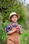 Portrait of one cute boy in a hat in the garden with a red apple, emotions, happiness, food. Autumn harvest of apples